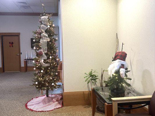 Whimsical Character and Christmas Tree in Office