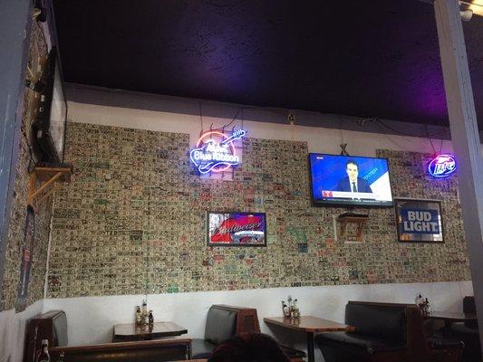 The wall is decorated with dolla dolla bills, y'all.