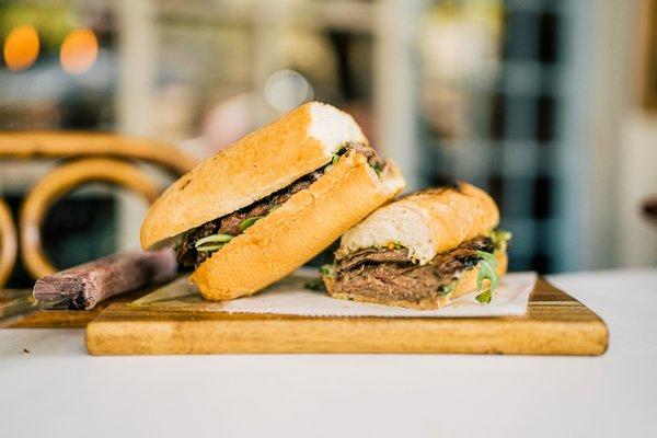 Sanguche Del Gaucho made with skirt steak, chimichurri, garlic aioli, sea salt, and french style bread.