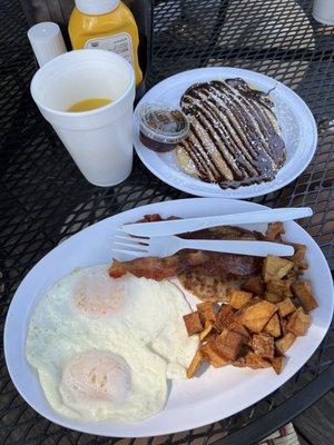 Fried eggs with home fries and chocolate pancakes.