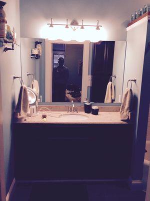 Removed old 30" plastic shower and installed new vanity and mirror.