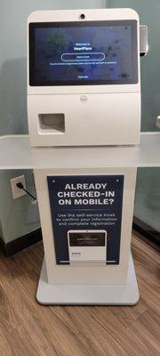 Self-check in. Put your insurance cards into slot and follow screen prompts