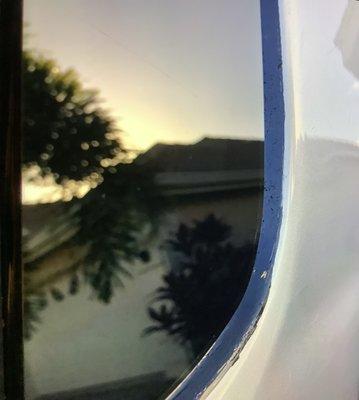 Black adhesive on outside of window