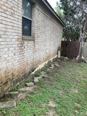 Before pressure wash on wall.