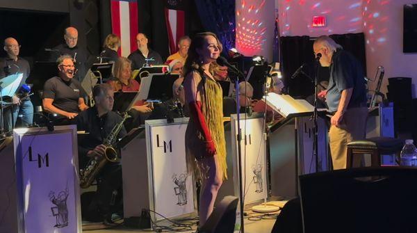 Nina Herzog singing lead, backed by the Ladd McIntosh Big Band