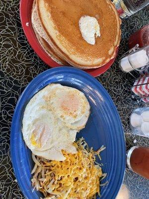 Pancake breakfast with 2 eggs, hash browns (bacon not shown)