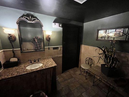 Women's Bathroom- Seat and Table, Full Sized Leaning Mirror, Beautiful Sink, Vanity Mirror, Sconces. Clean and well kept.