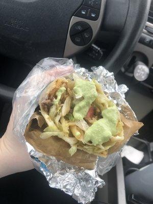 Steak burrito with spicy guacamole salsa from La Popular