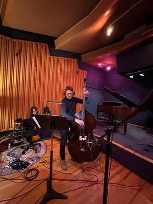 A-list session player Sean Hurley playing upright bass on a student's EP in the recording studio.