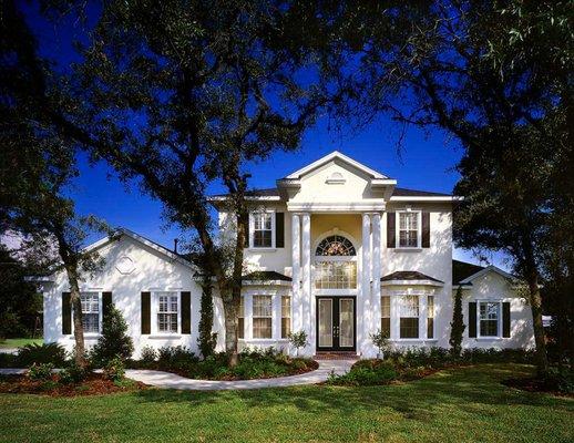 This two story custom designed home built by Rotunda Homes features a stunning front elevation with a side load garage.