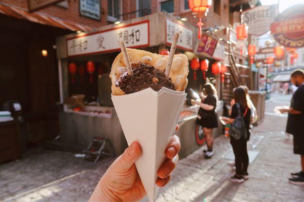 Ube Ice Cream Sesame Bubble Waffle Cone ube ice cream, toasted black sesame bubble waffle with cookie crumbs, pocky, Meiji panda cookie.