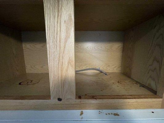 Soy sauce stains untouched in cabinet above the stove