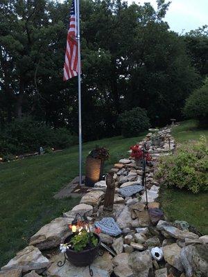 Reconfigured rock wall, also New concrete platform beneath flagpole