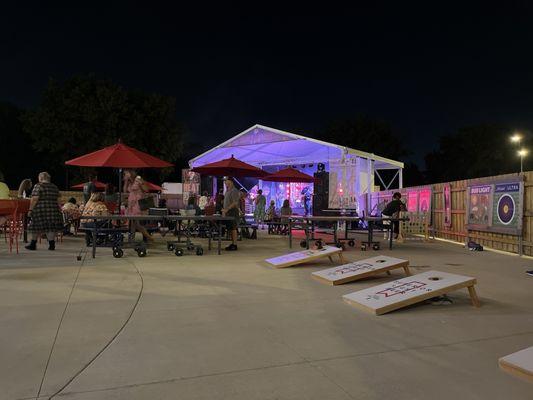 Patio area with live music, cornhole, and ping pong.