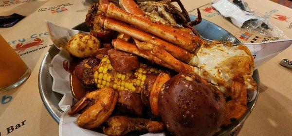 Mardi Gras Special: 1 lobster tail, 2 blue crabs, 1/2lb shrimp, 1/2lb snow crab legs, potatoes, corn, sausage, and eggs.