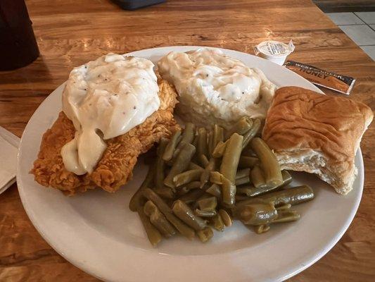 Chicken fried chicken, mashed potatoes, green beans, and a roll.