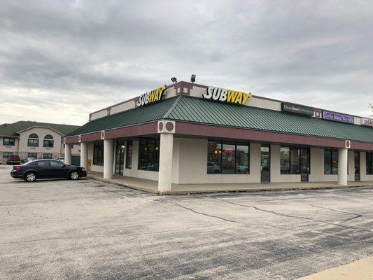 This subway is at the end of a strip mall.