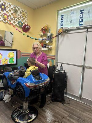 Lori and her car chair with tv set up