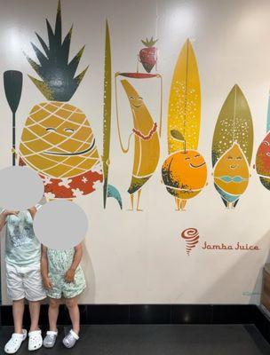 Inside - cute mural of fruits and surfboards!