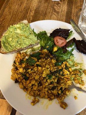 Tofu scramble with bread, mixed greens, and avocado spread