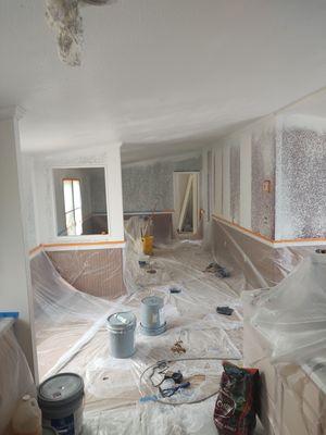 Interior drywall repair and primer being sprayed