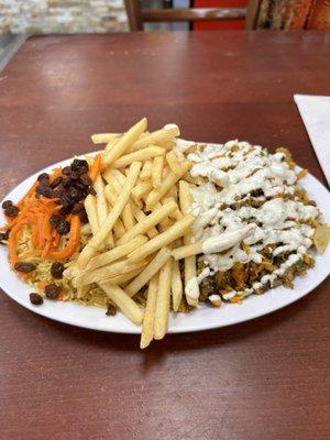 Platter with lamb, chicken, fries and rice...get the raisins and carrots, really enhances the flavor profile of this dish. A+