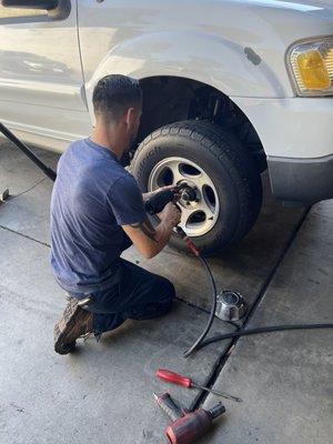 Owner looking at control arm by taking tire off to see if he installed the correct one, instead of actually taking it off and comparing.