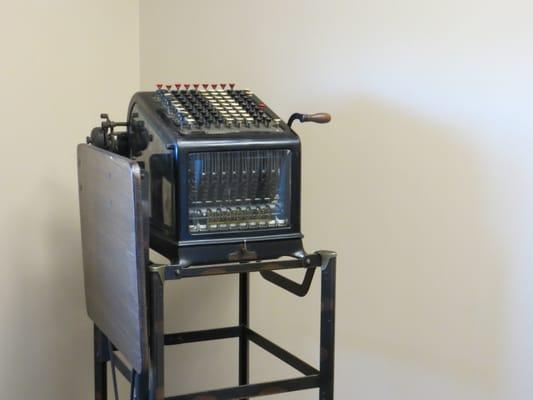 Antique adding machine on display.