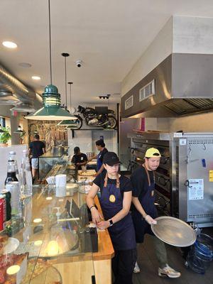 Inside of Elements pizzeria. Staff working hard on Labor Day