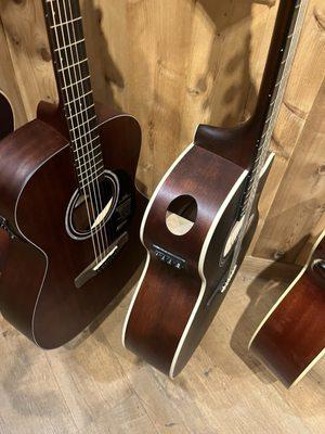 These are guitars hanging in their store with straight up missing sections. Used and abused instruments. Made me sick to see.