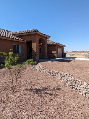 Front yard with dry river.