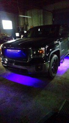 A 2015 Chevy Silverado newly outfitted with underneath glow lighting done at Wellsboro automotive