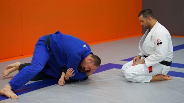 Coach Mike showing one of his Black Belts a Brabo Choke.