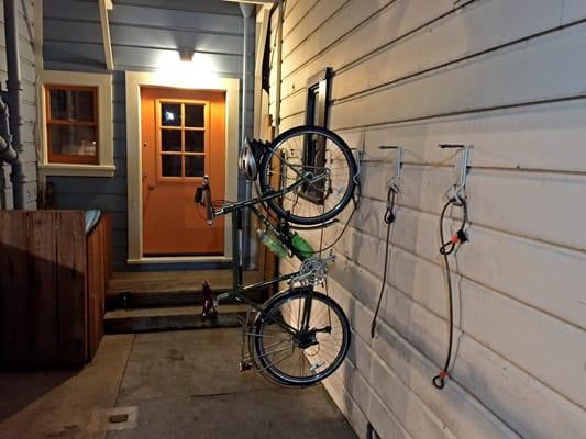 There are bike hooks with chains inside the protected gate of the house. Feels safer since the front desk looks out onto them.