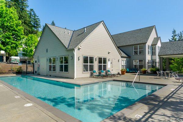 Swimming pool surrounded by lounge seating.