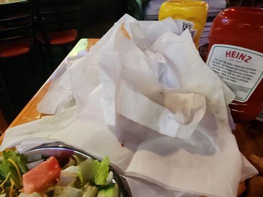 The pile of napkins used to try to get the grease out of 1 piece of the fish.