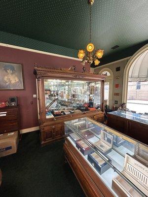 Historic display cabinet circa 1906-ish. The glass front rises up to access the contents.