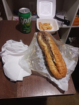 Philly cheesesteak with 20 fries eaten and a can soda a sprite. Philly cheesesteak combo!