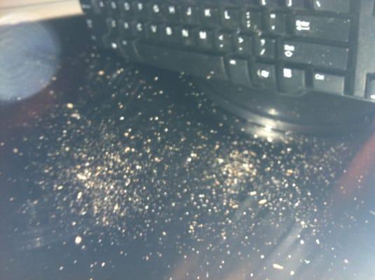 My desktop and computer, covered in dust and pebbles from the ceiling and walls above