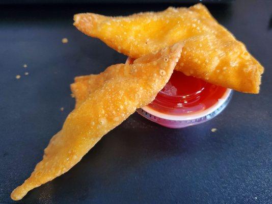 Crab Rangoons with sweet and sour sauce. Fried just right and creamy goodness inside