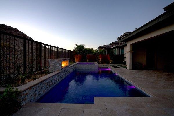 This back yard started out as dirt and we designed and added a pool, fire features and beautiful deck with plants and trees surrounding it.