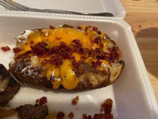 Baked potato with butter salt cheese and bacon