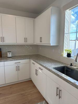 Subtle herringbone backsplash. Looks great and they even did inside the window sill for us.