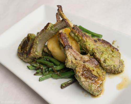 Lamb lollipops over polenta cake and green beans.