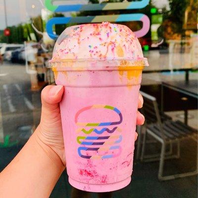 Pride Shake: strawberry and blackberry frozen custard topped with a mango and passion fruit blend, whipped cream and rainbow glitter