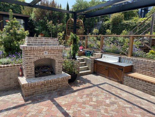 After:  retractable shade, brick fireplace, vintage sink and soapstone counter, ipe cabinet, ipe bench, arbor