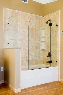 This "sail" style shower door allows easy access to bathe small children without a traditional sliding door in the way.