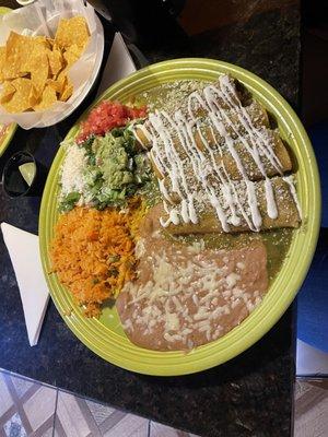 Verde Chicken enchiladas with rice and beans.