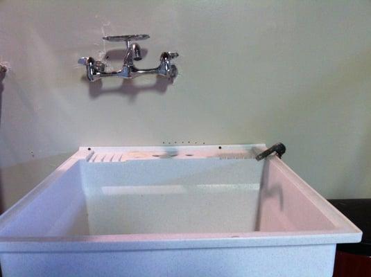 Here's great shot of the crooked sink Boris installed. Notice all the holes in the wall where he tried to mount the sink.