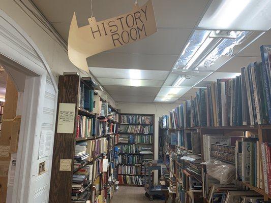 Stacks, pointing towards a whole room of history books